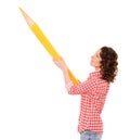 young pretty woman with huge yellow pencil Royalty Free Stock Photo