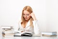 Young pretty woman learning at table with books