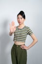 asian young woman looking serious, stern, displeased and angry showing open palm making stop gesture Royalty Free Stock Photo