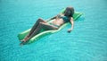 Young pretty woman lying on air mattress in the swimming pool Royalty Free Stock Photo