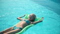 Young pretty woman lying on air mattress in the swimming pool Royalty Free Stock Photo