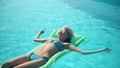 Young pretty woman lying on air mattress in the swimming pool Royalty Free Stock Photo