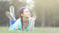 Young pretty woman lying on grass at summer sunset. Natural happiness, fun and harmony. Royalty Free Stock Photo