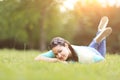 Young pretty woman lying on the grass at summer sunset. Natural happiness, fun harmony. Royalty Free Stock Photo