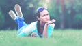 Young pretty woman lying on the grass at summer sunset Royalty Free Stock Photo