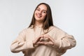 Young pretty woman making heart symbol by hands on isolated white background. Romantic concept Royalty Free Stock Photo