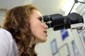 Young pretty woman ophthalmologist optometrist optician examins visual acuity of a patient,