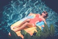 Young pretty woman with perfect tanned body lying on air mattress in the pool in summer and having fun. Relaxing Royalty Free Stock Photo