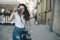 Young pretty woman photographer walk by old city street with retro camera Royalty Free Stock Photo