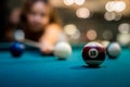 young pretty woman playing alone snooker holding cue at pool table Royalty Free Stock Photo