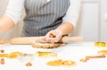 Young pretty woman prepares the dough and bakes gingerbread and cookies in the kitchen. Merry Christmas and Happy New Royalty Free Stock Photo