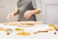 Young pretty woman prepares the dough and bakes gingerbread and cookies in the kitchen. Merry Christmas and Happy New Royalty Free Stock Photo