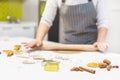 Young pretty woman prepares the dough and bakes gingerbread and cookies in the kitchen. Merry Christmas and Happy New Royalty Free Stock Photo