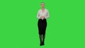 Young pretty woman presents something on a Green Screen, Chroma Key.