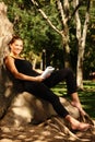 Young pretty woman reading in the park Royalty Free Stock Photo