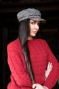 Young pretty woman in red sweater and pied de poule hat Royalty Free Stock Photo