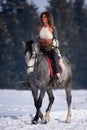 Young woman riding horse outdoor in winter Royalty Free Stock Photo