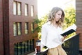 Young pretty woman sitting at opened window drinking tea and reading a book enjoys of rest Royalty Free Stock Photo