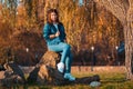 A young pretty woman is sitting on a rocks in an autumn park. The concept of psychology Royalty Free Stock Photo