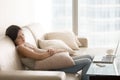 Young pretty woman sleeping on couch, taking nap on sofa Royalty Free Stock Photo