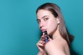 Young pretty woman smelling perfume. Sensual woman with bottle of perfume, beauty portrait. Female perfume, fragrance Royalty Free Stock Photo