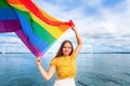 Young pretty woman smile and hold rainbow flag