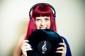 Young pretty woman smiling and biting vinyl record close up Royalty Free Stock Photo