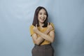 Young pretty woman smiling joyfully and looking happy, feeling carefree and positive with both thumbs up  by blue Royalty Free Stock Photo