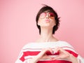 Young pretty woman  smiling and looking at camera with hands on chest, love gesture and kiss. Happy smiling woman feels love, Royalty Free Stock Photo