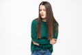 Young pretty woman with stomack pain wearing in green sweater isolated on white background