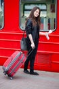 Young pretty woman with a suitcase on the train station Royalty Free Stock Photo