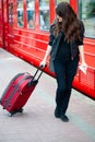 Young pretty woman with a suitcase on the train station Royalty Free Stock Photo