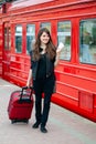 Young pretty woman with a suitcase on the train station Royalty Free Stock Photo