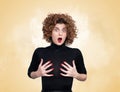 Young pretty woman with a surprised expression on her face grabbing her chest with her hands. On yellow and smoke background