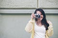 Young pretty woman taking picture with old camera Royalty Free Stock Photo