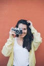 Young pretty woman taking picture with old camera Royalty Free Stock Photo