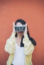 Young pretty woman taking picture with old camera Royalty Free Stock Photo