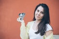 Young pretty woman taking picture with old camera Royalty Free Stock Photo