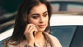 Young pretty woman talking on mobile phone outdoors. Sensual girl with makeup. Girl using phone Royalty Free Stock Photo