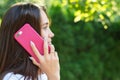 Young pretty woman talking  smartphone. Beautiful girl calling phone. Female profile with telephone in her hand Royalty Free Stock Photo