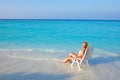 Young pretty woman tans in beach chair Royalty Free Stock Photo