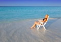 Young pretty woman tans in beach chair.Portrait in a sunny day Royalty Free Stock Photo