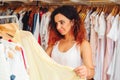 Young pretty woman trying on new dress in clothing store.Shopping time. Summer sale. Royalty Free Stock Photo