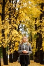 Young pretty woman walking in the autumn park Royalty Free Stock Photo