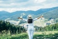 Young pretty woman walking by mountain peak