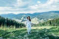 Young pretty woman walking by mountain peak