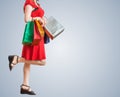 Young pretty woman is walking and shopping with colorful bags Royalty Free Stock Photo