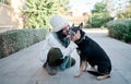 Young and pretty woman in a white cap hugs and kisses her dog with one eye of each color. Love between owner and dog Royalty Free Stock Photo