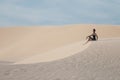 Young pretty woman in white sand dunes like a Royalty Free Stock Photo