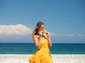 Young woman eating corn on the beach Royalty Free Stock Photo
